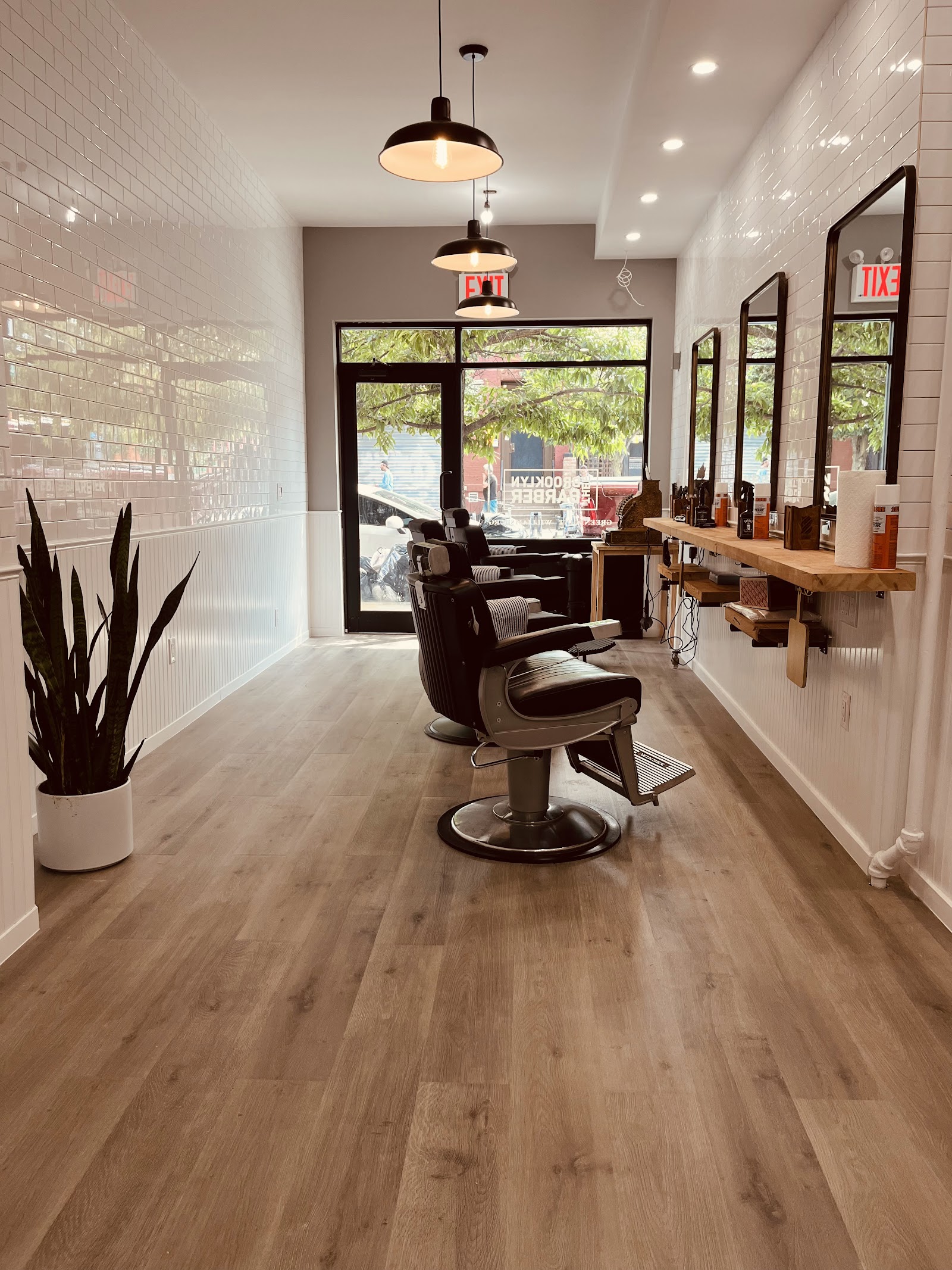 Barber chairs and white tiled walls inside the Nassau Avenue shop